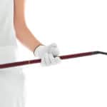 Woman holding golf club and ball