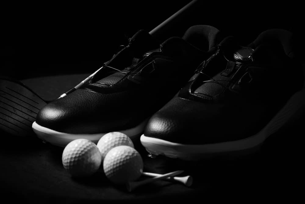 black golf shoes and balls