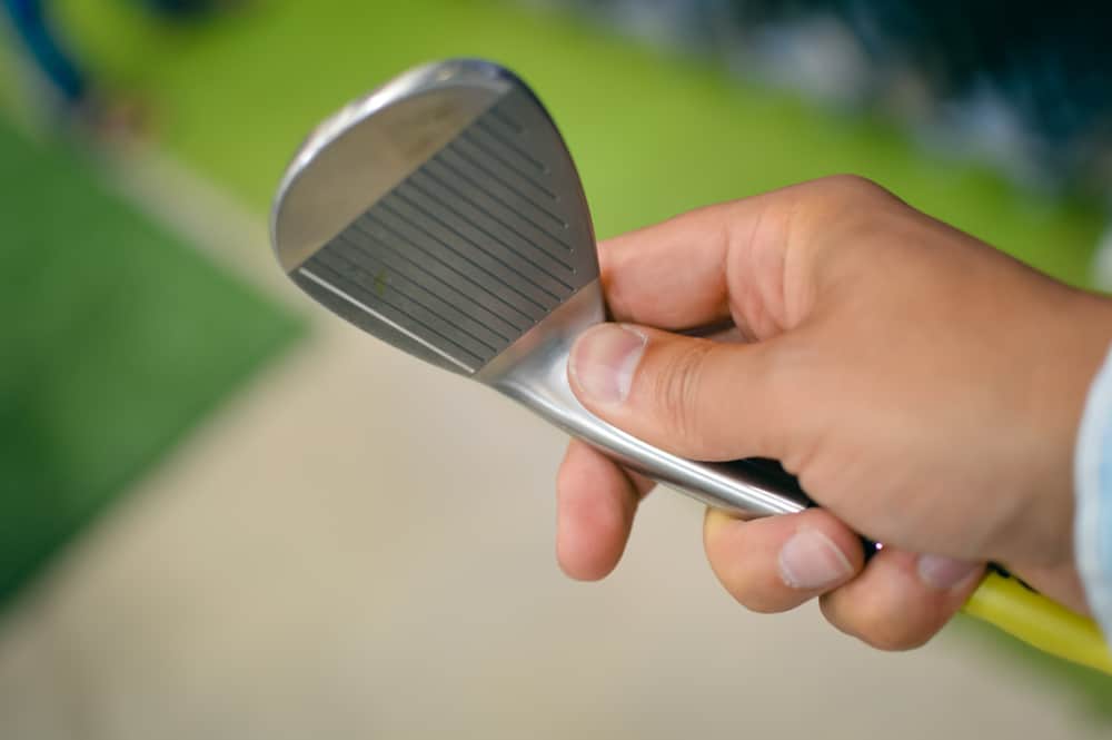 Choosing golf club on retail shop