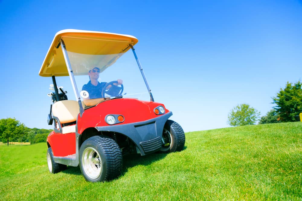 Man Driving A Golf Cart