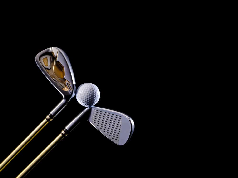 Golf club and golf ball on a black background