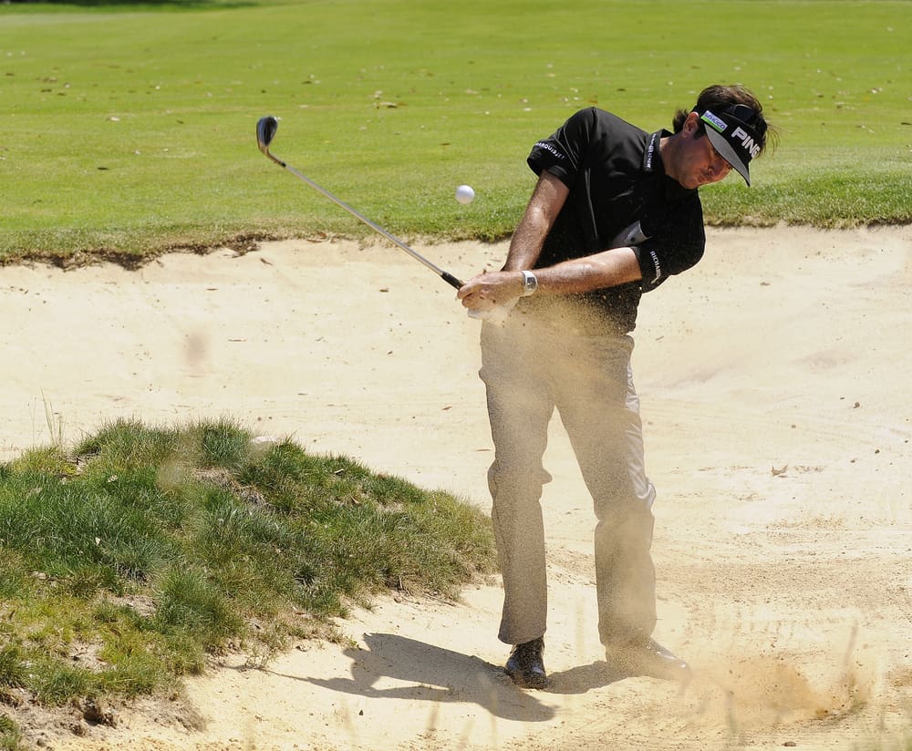 American Bubba Watson explodes a bunker shot with a ping golf club