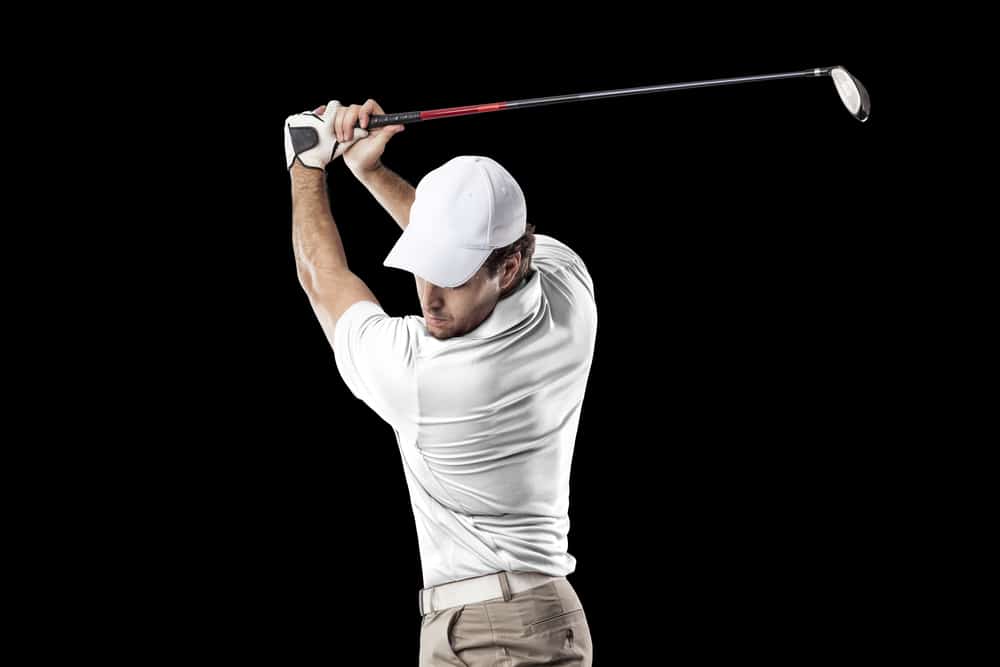 Golf Player in a white shirt taking a swing