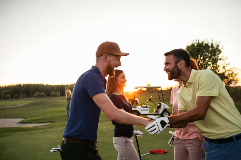 Golfing partners shaking hands