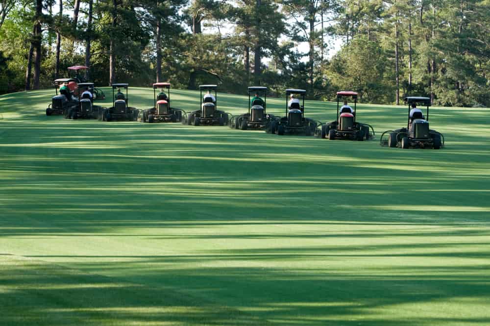 Groundskeepers at Augusta National performing synchronized mowing and golf course maintenance activities