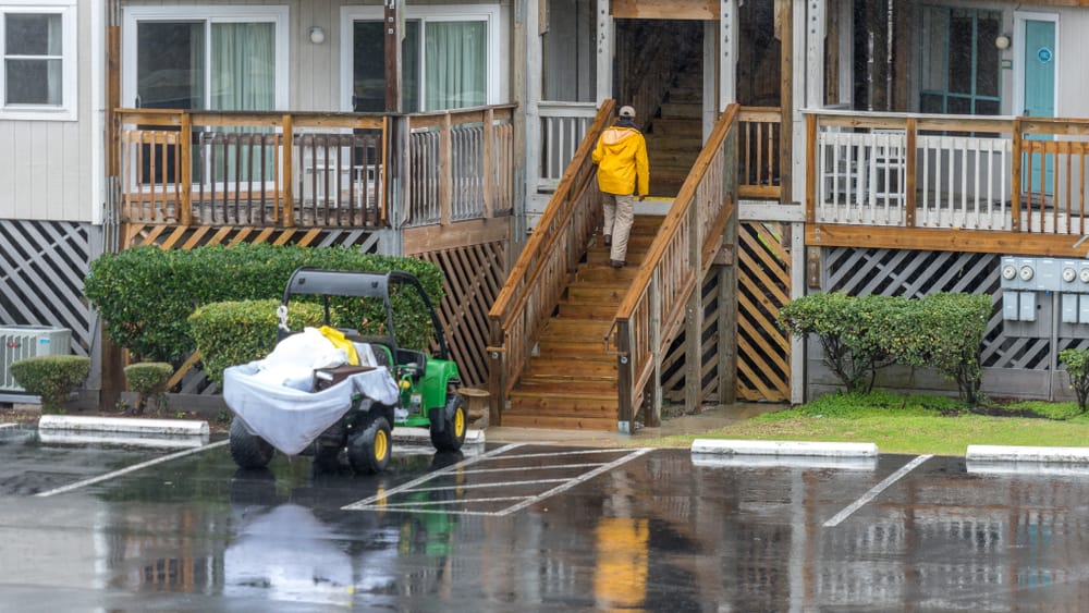 Maintenance worker, cart on rain