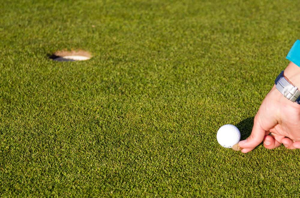 Marking golfball on putting green