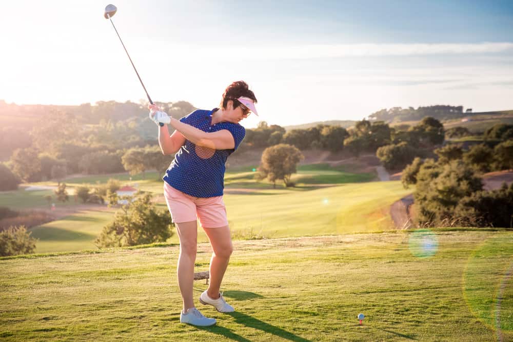 Mature woman playing golf