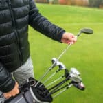 Professional golf player choosing the golf club from the bag