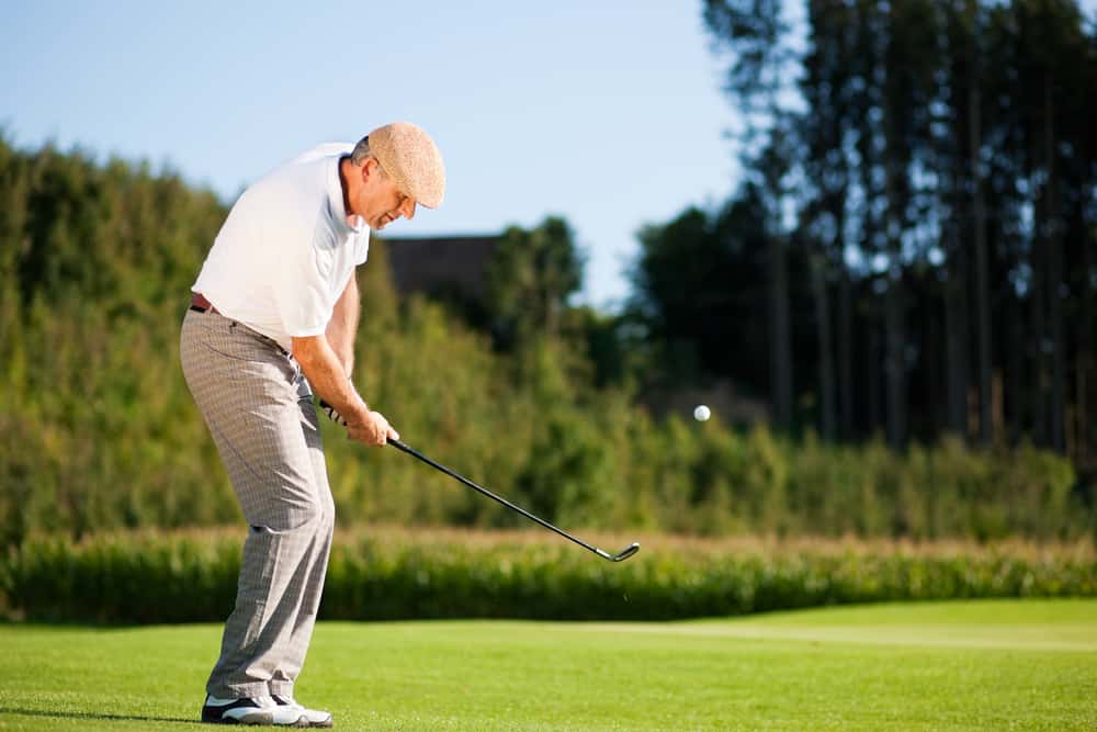 Senior golfer doing a golf stroke