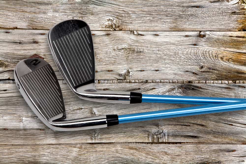 Two golf clubs on wood