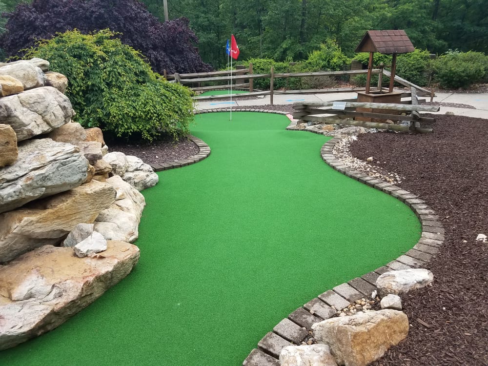 green artificial grass and rocks on miniature golf course