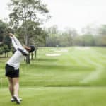 lady golf swing on golf course