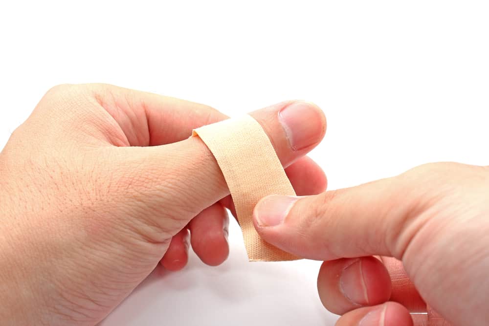 putting bandage on thumb