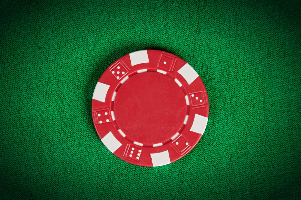 red poker chip on green table