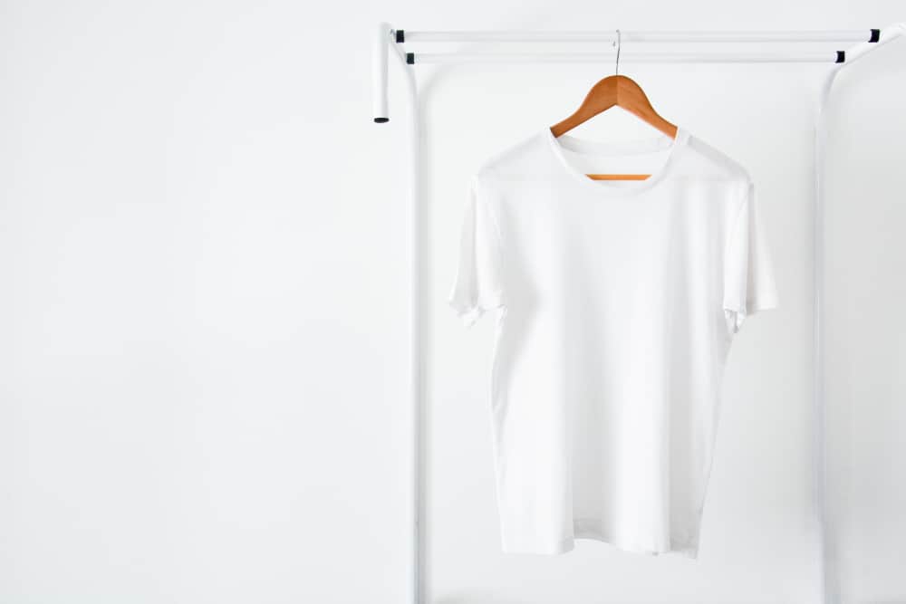 t-shirt hanging on wooden clothes hanger