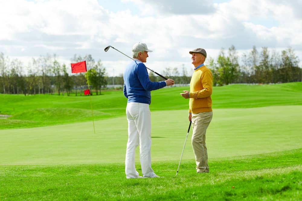 two mature men in casualwear discussing news or plans