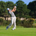 American golfer Dustin Johnson plays a fairway shot