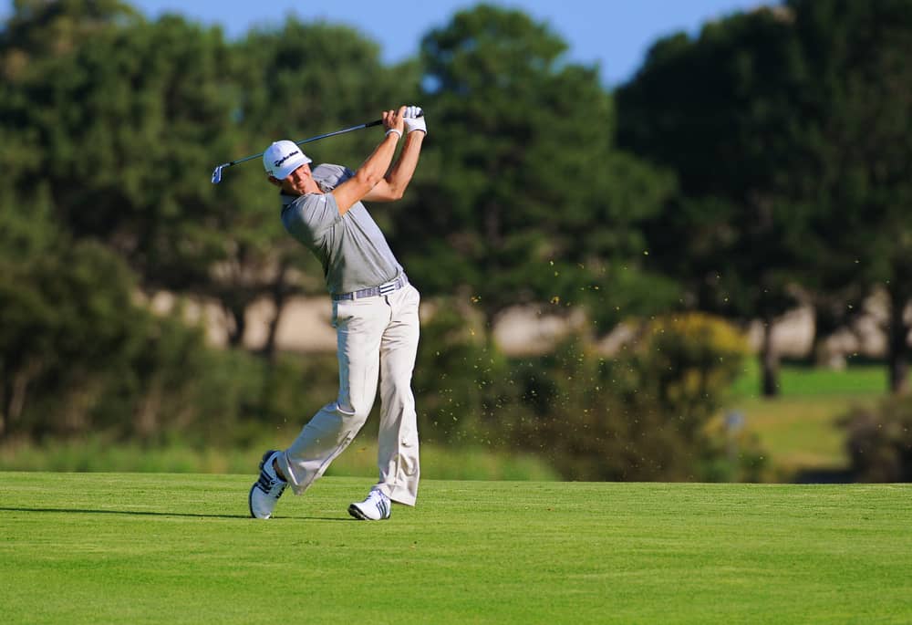 American golfer Dustin Johnson plays a fairway shot