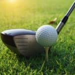 Close up of golf ball on a tee with the driver