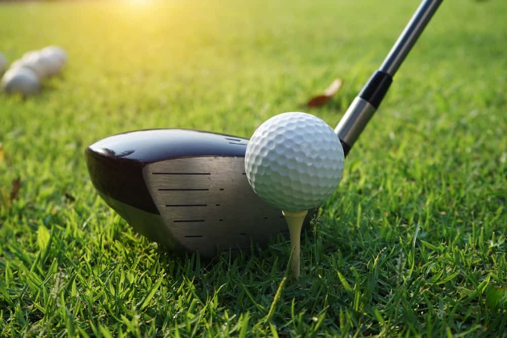 Close up of golf ball on a tee with the driver