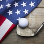 Golf ball with flag of USA on wood table