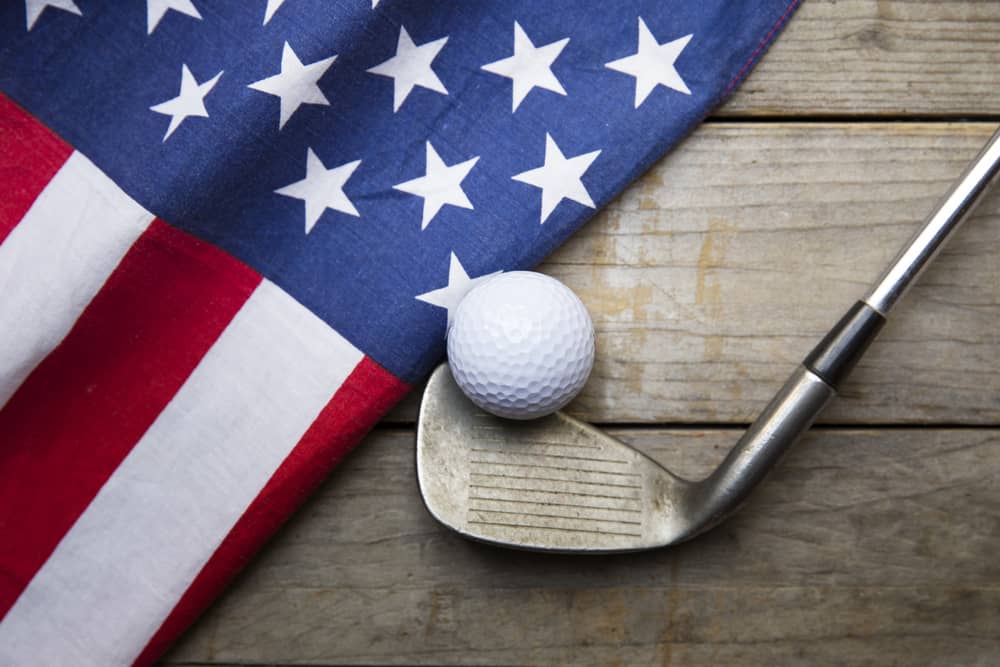 Golf ball with flag of USA on wood table