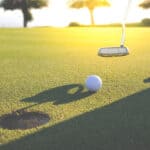 Golf club and ball in grass at the Golf course