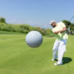 Golf player hitting the ball
