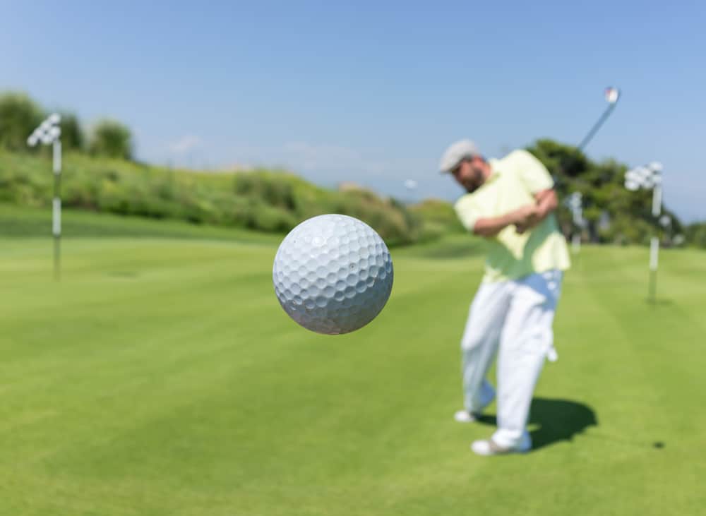 Golf player hitting the ball