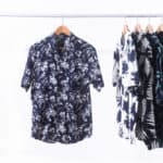 Row of short sleeved and T-shirt coconut ,tree, floral, leaves, tropical plant, fruit pattern on hanger