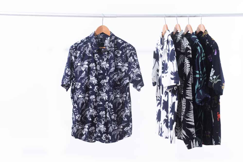 Row of short sleeved and T-shirt coconut ,tree, floral, leaves, tropical plant, fruit pattern on hanger