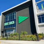 The building exterior of a Drive Shack where people can play interactive golf games, eat, and drink with friends