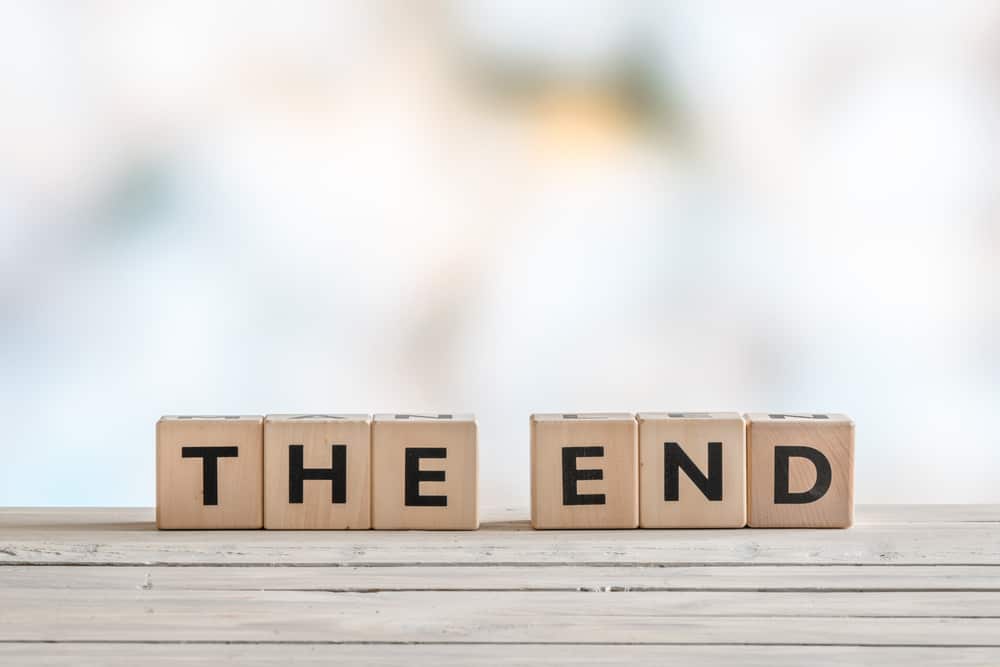 The end sign with wooden blocks on a table