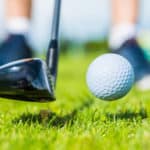 golf ball ang club on golf green grass natural fairway