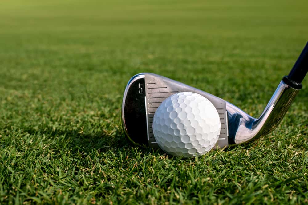 golf ball on fairway with iron