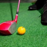 golf club and yellow golf ball