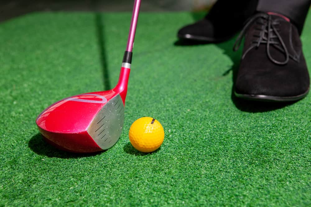 golf club and yellow golf ball