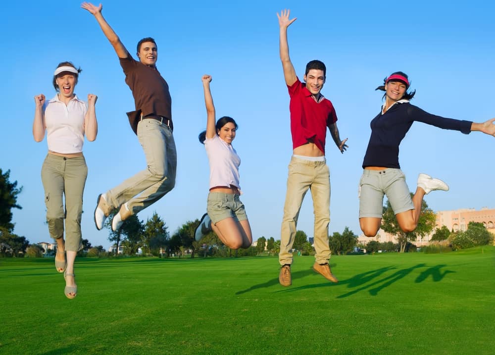 happy jump group of young people jumping outdoors