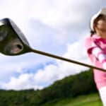 young girl preparation to drive golf