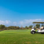 A Golf cart and golf clubs bag with shadow reflection