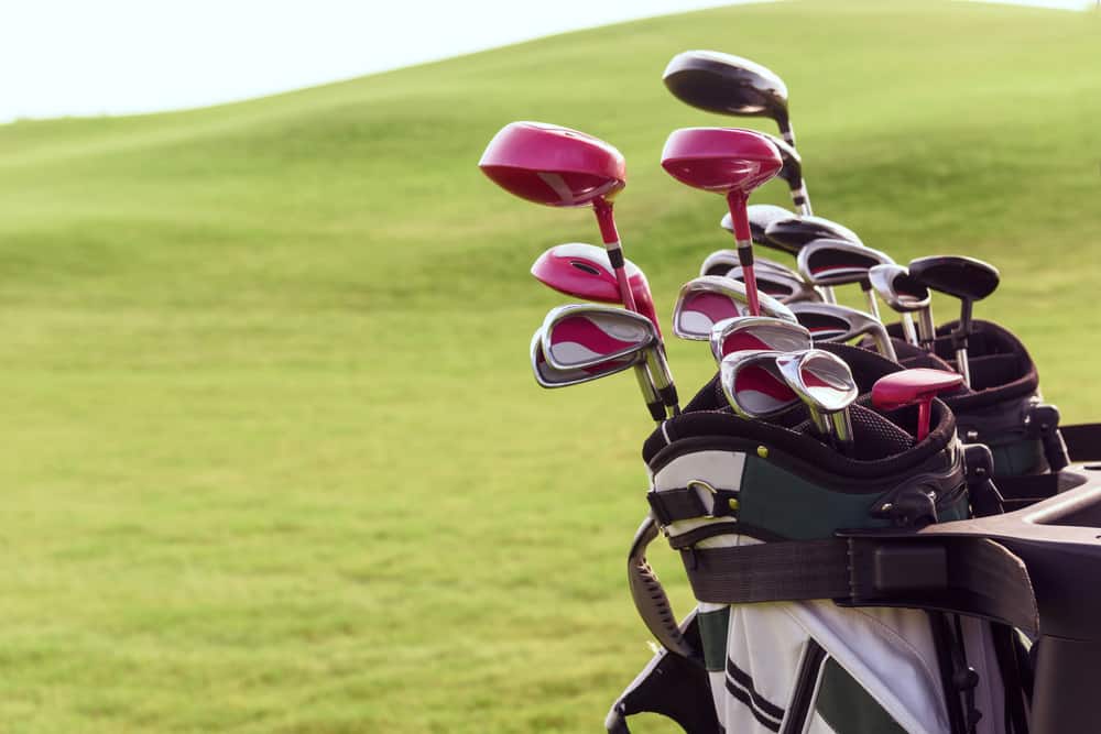 Close up of bag full of different golf clubs