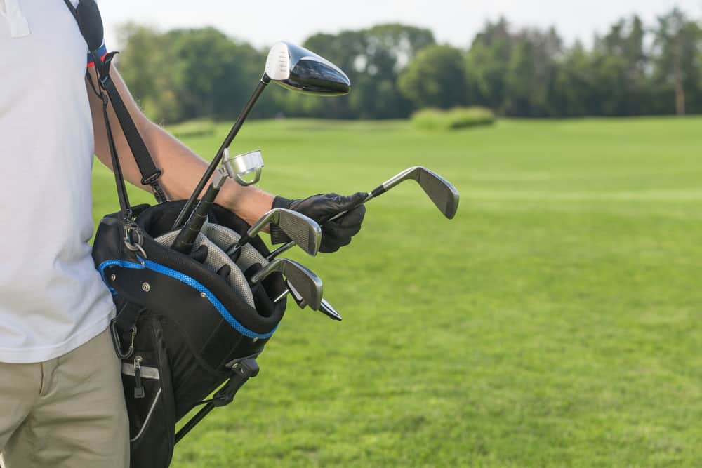 Close-up picture of golf bag hold by a golfer.