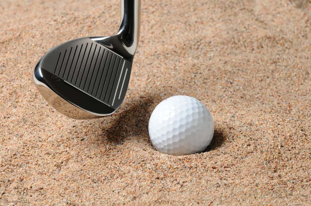 Golf Ball in Trap with Sand Wedge