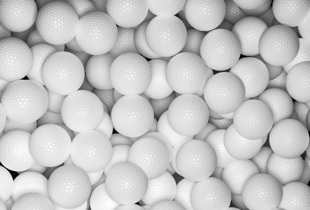 Golf balls multitude close up