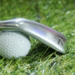 Golf iron and ball on green grass - iron 7