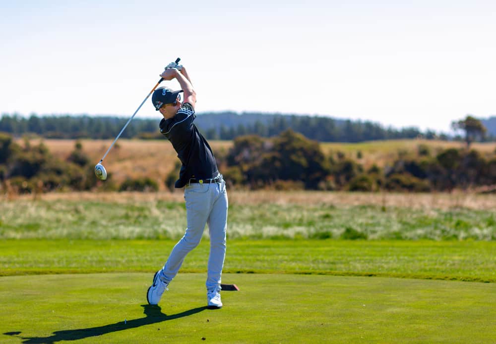 Golf player is practicing on the golf field