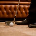Man playing golf at office