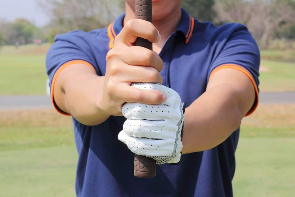 Man preparing to grip a golf club