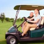 Side view of two golfer driving cart